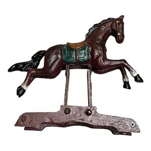 Cast iron painted horse spring loaded on base, moveable.
